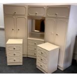 A Rococo style bedroom suite comprising two wardrobes, a vanity unit with hopper over mirrored