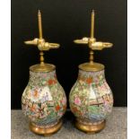 A pair of contemporary Chinese porcelain table lamps, decorated with traditional figures, twin light