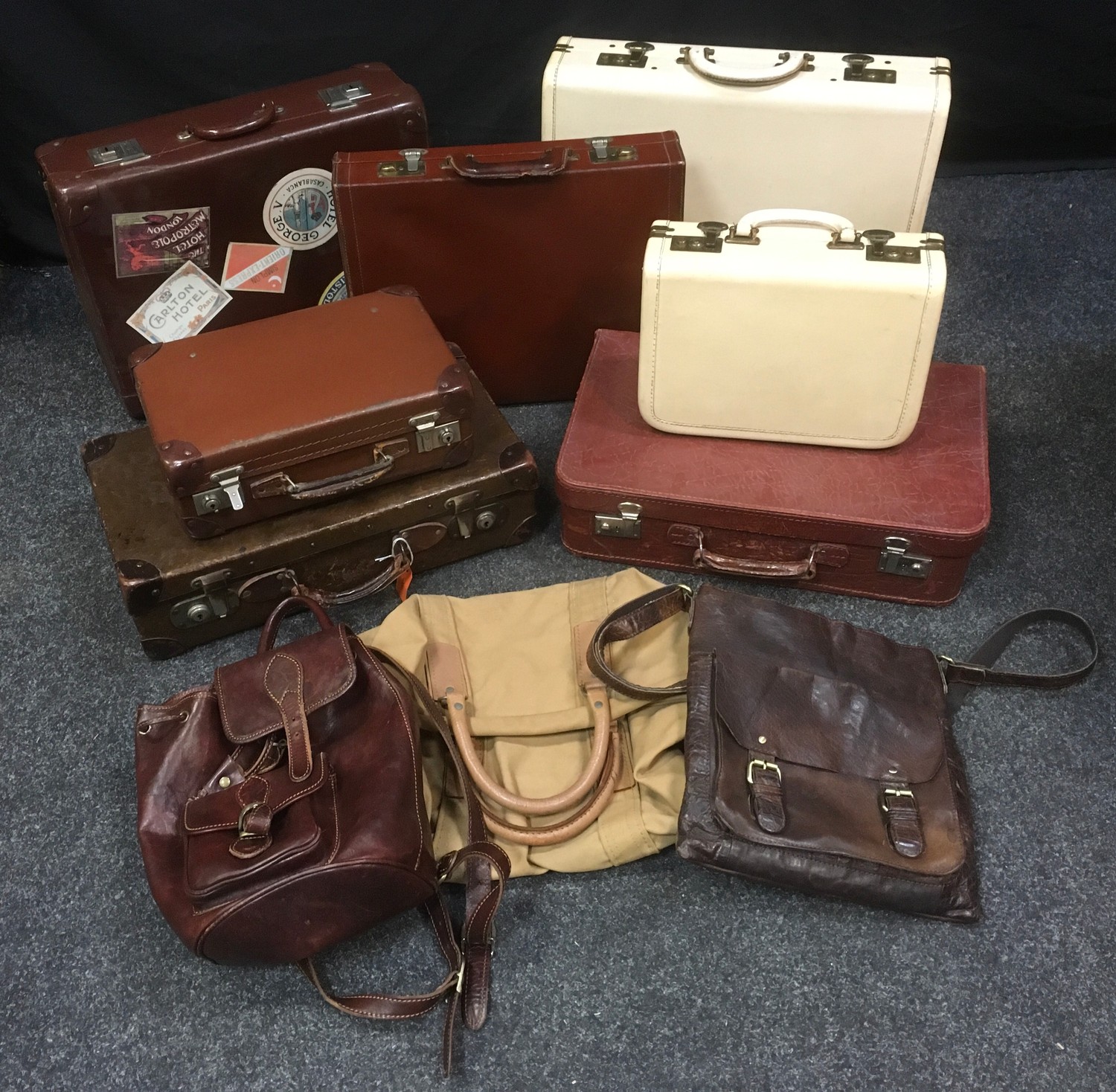 Vintage luggage - a leatherette overnight suitcase with matching vanity case; a leather briefcase;