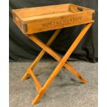 A folding tray table, the rectangular tray top, each side with a different Champagne