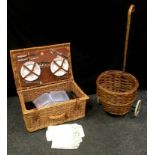 An Ealing Hampers wicker cased picnic set for four; a wicker crook handled oval trolley.