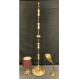 An onyx and gilt brass standard lamp; a lacquered brass scallop shell desk lamp; an onyx table