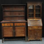 A 20th century oak bureau bookcase, of narrow proportions, dentil cornice above a pair of glazed