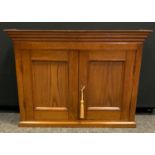 A 20th century oak wall hanging cupboard, stepped cornice above a pair of cupboard doors, 51cm high,
