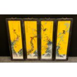 A set of four contemporary Chinese rectangular porcelain panels, each decorated with fanciful birds,