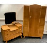 A mid 20th century oak veneered bedroom suite comprising a double wardrobe 186cm high and a dressing