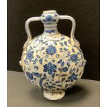 A contemporary Chinese twin handled blue and white moon flask vase, decorated with trailing