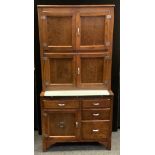 A 20th century oak kitchen utility unit, two pairs of cupboard doors, the projecting base with a