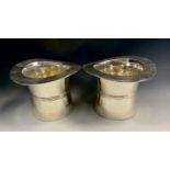 A pair of silver plated ice bucket coolers as Top Hats, 17cm high, 24cm wide (2).