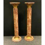 A pair of red marble octagonal topped pedestals, circular columns, stepped feet, 114cm high, 27.