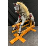 A painted wooden rocking horse, dapple grey body, hair main and tail, leather saddle, 65cm saddle