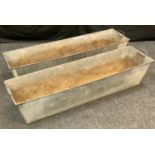 Two galvanized rectangular planters, sing handles to ends. 28cm high x 127cm long x 34cm wide.