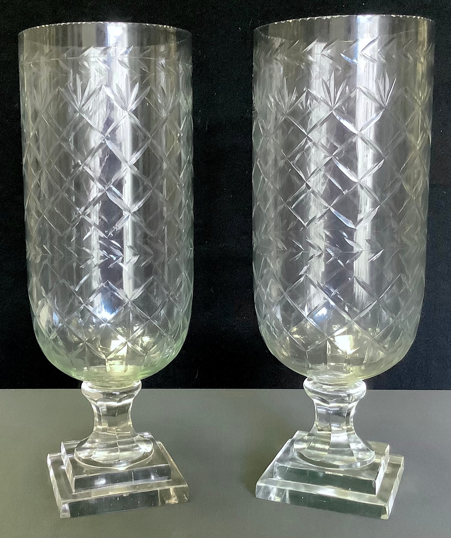 A pair of contemporary cut glass storm shades, stepped square bases, 40cm high