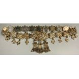 A 20th century Ottoman Turkish silver coloured metal belly dancers belt, articulated fringe,