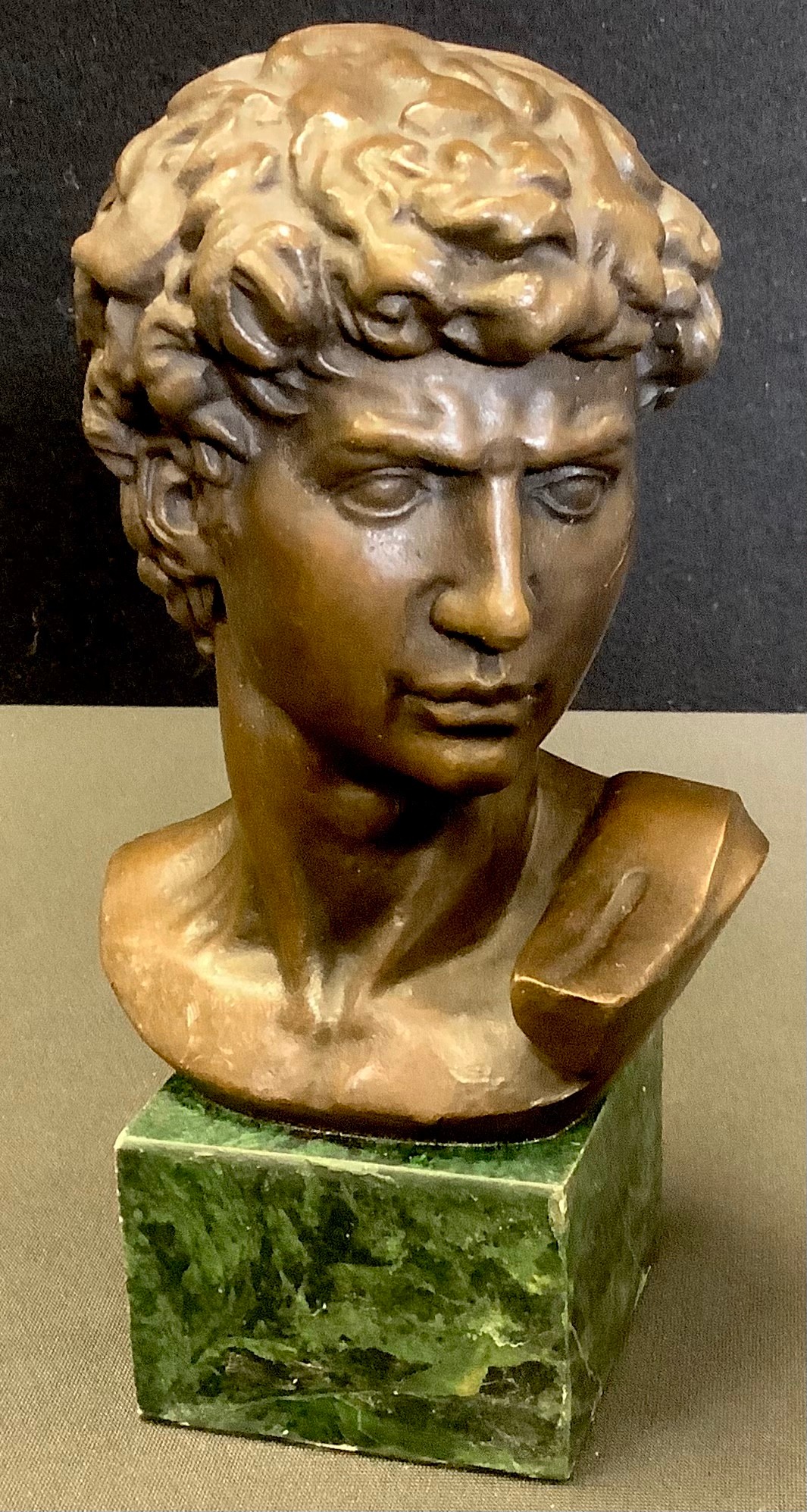 After Michelangelo, a contemporary bronze bust, David, green verdigris base, 16cm high