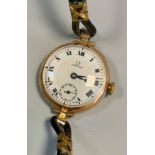 Omega - a 1920s 9ct gold cased wristwatch, white enamel dial, bold Roman numerals, subsidiary