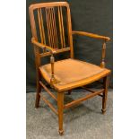 An Edwardian mahogany open arm chair, outlined throughout with ebony and boxwood stringing,