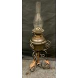 An Arts & Crafts wrought iron and copper oil lamp, scrolling triform base, Messengers No2