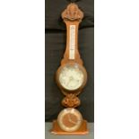 A early 20th century aneroid carved oak barometer/thermometer, white scales, 87cm high; a Metamec