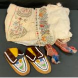 A pair of Tibetan child's leather shoes, striped red white and blue toes; a pair of leather bead