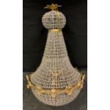 A large contemporary bag shaped ceiling light, with prismatic beads and silvered wired frame, gilt