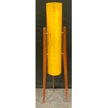A retro floor standing Rocket lamp, amber conical shade, on three teak stands