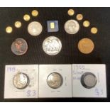 A Swiss 999.9 1 gram bar; America gold coloured dollar copy coin; others; a silver 1942 half