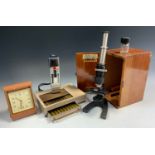 An early 20th century Britex Minor monocular microscope, four prepared slides, others blank,