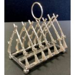 A modern silver plated toast rack, the bars as rifles, 11.5cm wide