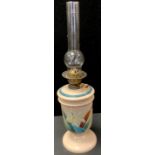 A Victorian coffee coloured milk glass oil lamp, painted decoration, 68cm high. c.1890.