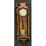 A late 19th century Vienna ebonised walnut wall time piece, white dial, Roman numerals, shaped and