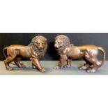 Contemporary School, a pair of brown patinated bronzes, Lions, standing, 32cm wide