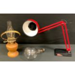 A red angle poise lamp; Chris Withers turned oak oil lamp, vintage giant screw thread bulb.