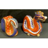 A Royal Crown Derby Dragon paperweight; another Serpent, both gold stopper (2)