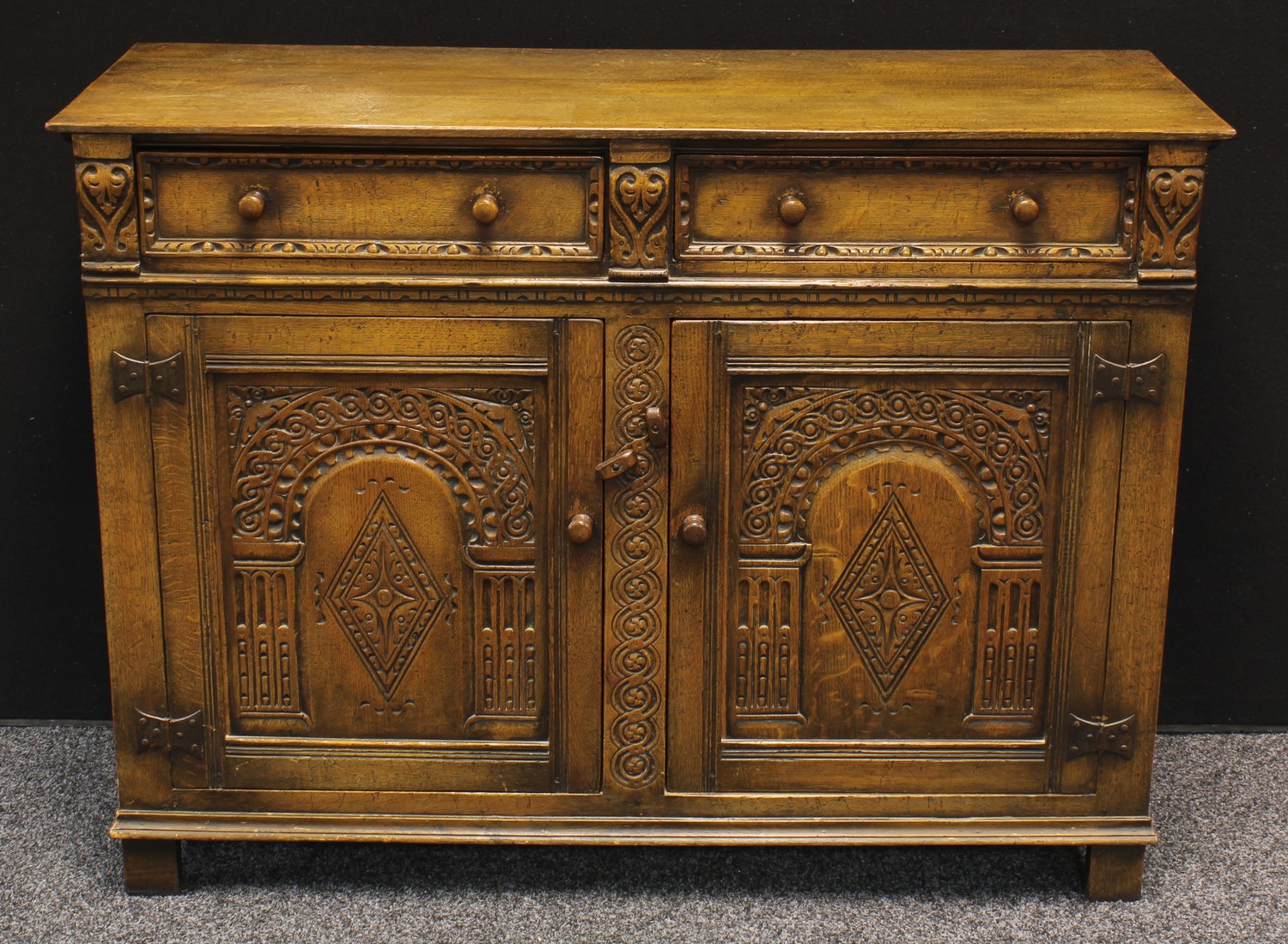 A 20th century oak kitchen sideboard, slightly over sailing rectangular top above a pair of short