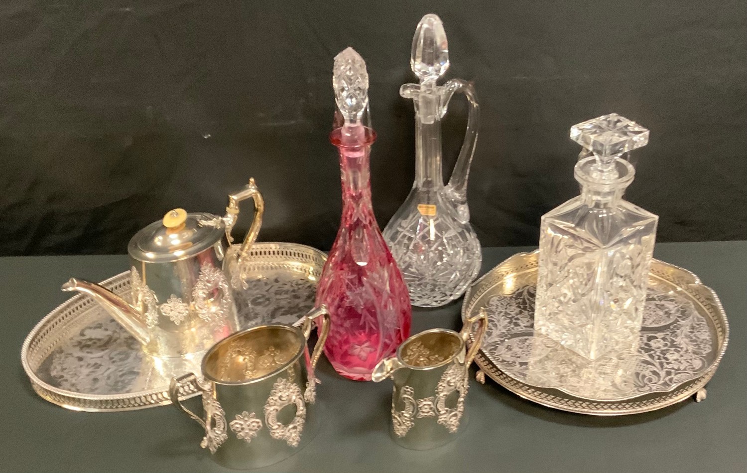 A Victorian silver plated three piece tea service, embossed floral motif; oval tray; circular