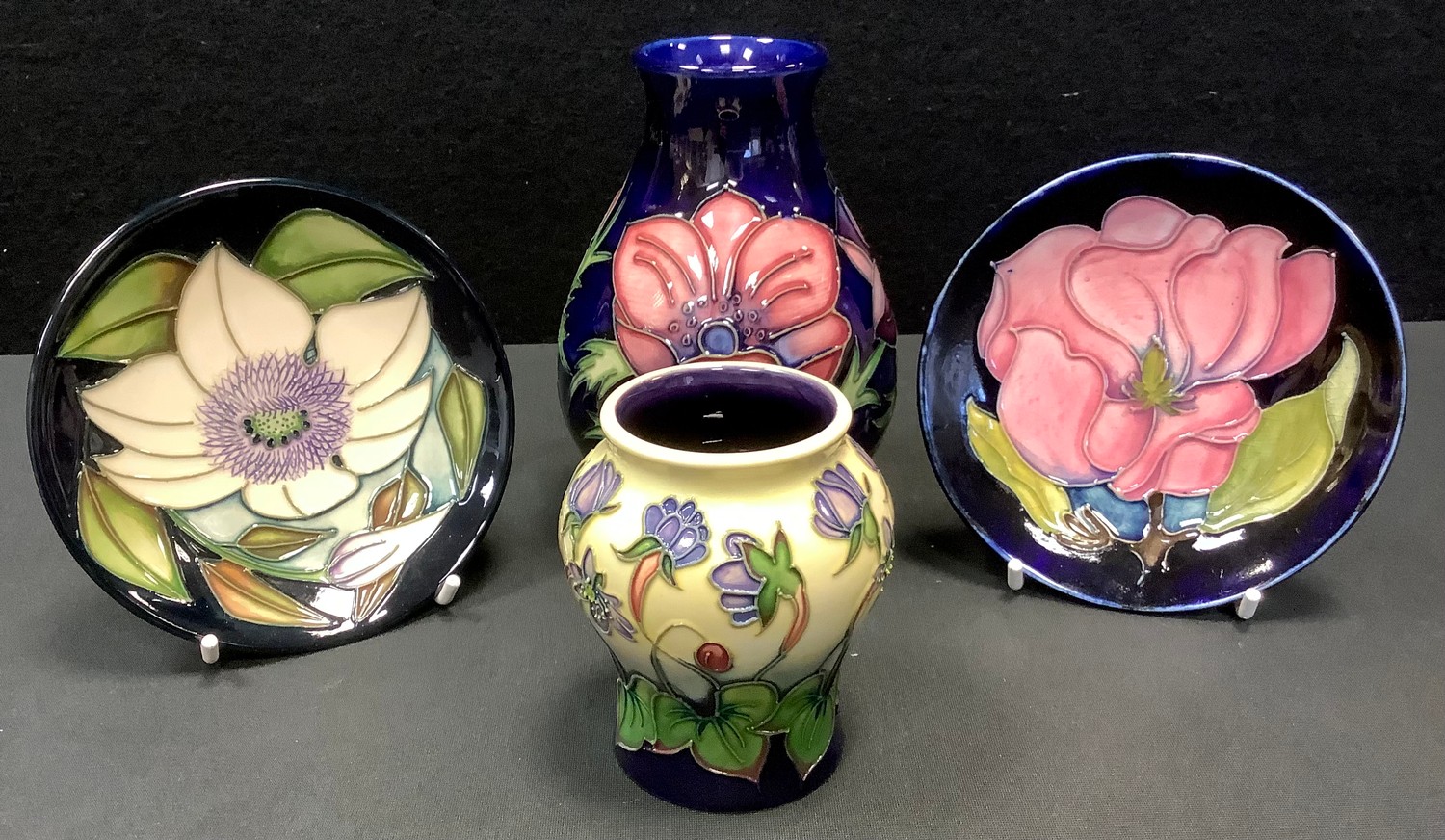 A Moorcroft Anemone pattern bulbous vase, 34/94, 13.5cm high; a Hepatica pattern squat vase designed