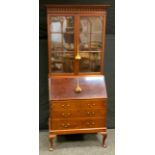 An early 20th century mahogany bureau bookcase, moulded cornice above a pair of astragal doors
