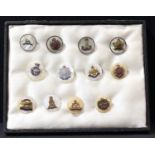 A collection of twelve mother of pearl military sweetheart brooches, some silver mounted