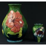A Moorcroft Hibiscus pattern baluster vase, 19cm; a Moorcroft Orchid pattern inverted baluster