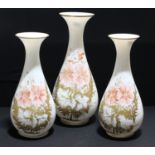 A garniture of three Victorian milk glass vases, enamel and gilt flowers, tha tallest 33.5cm high