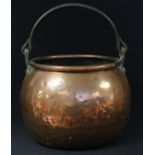 A 19th century copper cooking cauldron, wrought iron swing handle, 35cm diameter