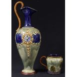 A Royal Doulton stoneware ewer, monogrammed, 29cm; a smaller jug (2)