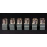 An Edwardian set of six silver napkin rings, chased and engraved with scrolls, Chester 1904, approx.