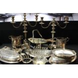 A pair of plated three light candleabra; siphon holders; toast racks; cake baskets; sauce boat; etc