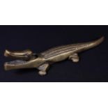 A brass novelty lever-action table-top nutcracker, as a crocodile, 36cm long, mid-20th century