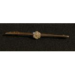 A 15ct gold and platinum diamond bar brooch, set with a flower head cluster of seven brilliant cut