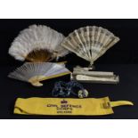 A French lace fan, silk and sequin, 35cm wide; an ivorine fan; others; a post-WWII Civil Defence