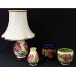 A Moorcroft Magnolia pattern baluster table lamp, 20cm; a Moorcroft Hibiscus pattern jardiniere,
