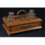 A Victorian oak brass mounted desk stand, pair of cut glass ink bottles, pen tray, single drawer